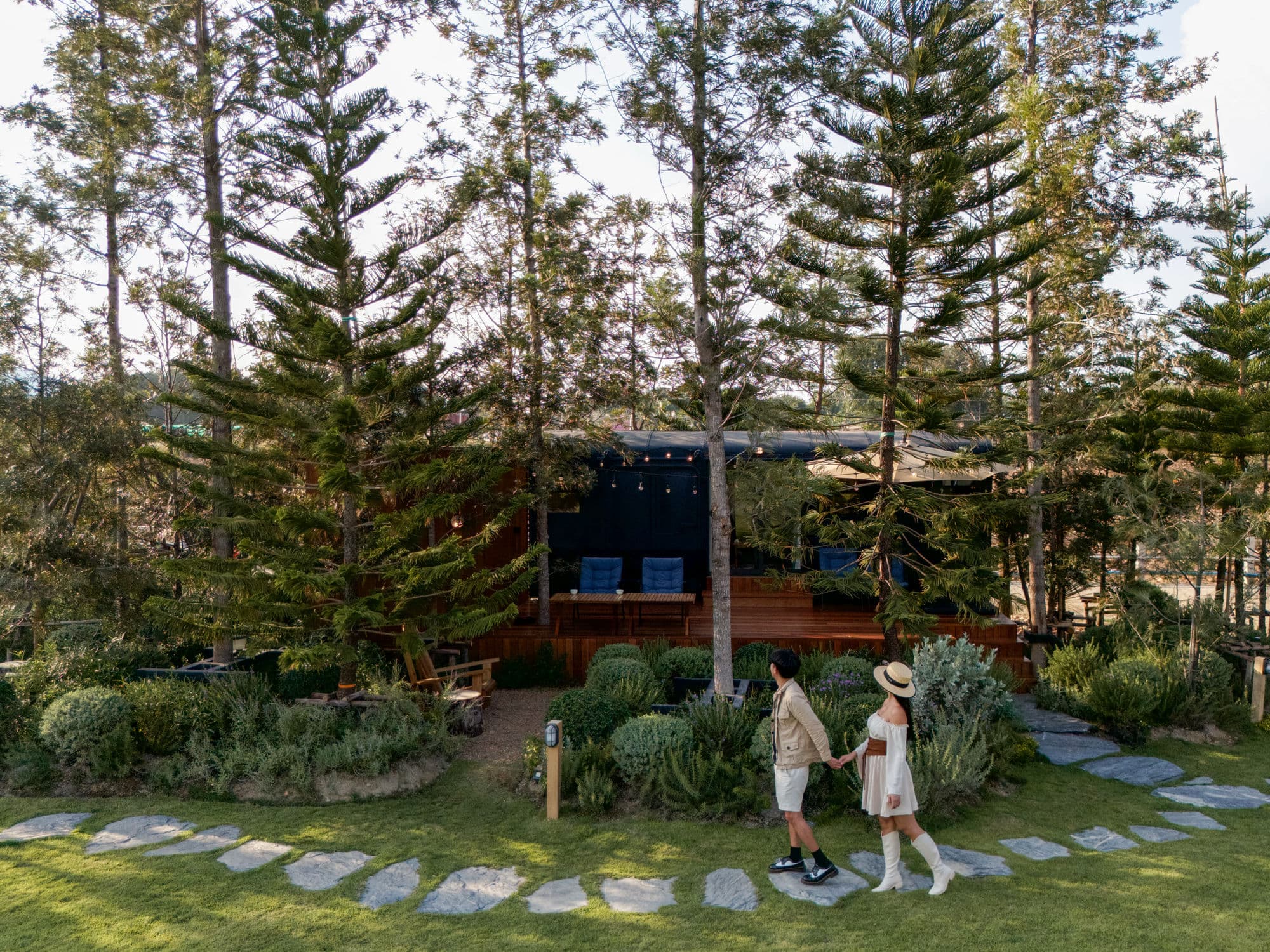 Couple walking on stone path through the pines