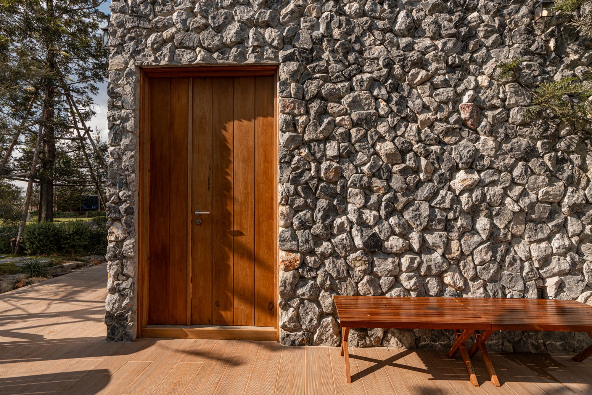 Stone villa exterior with adirondack chairs