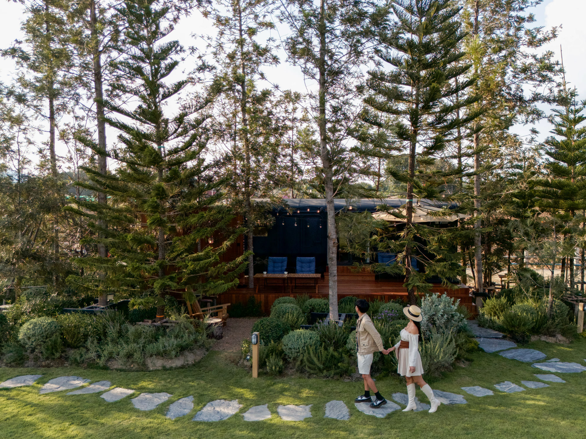 Couple walking on stone path through the pines