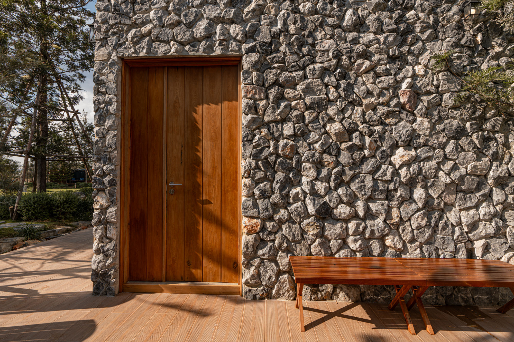 Stone villa exterior with adirondack chairs