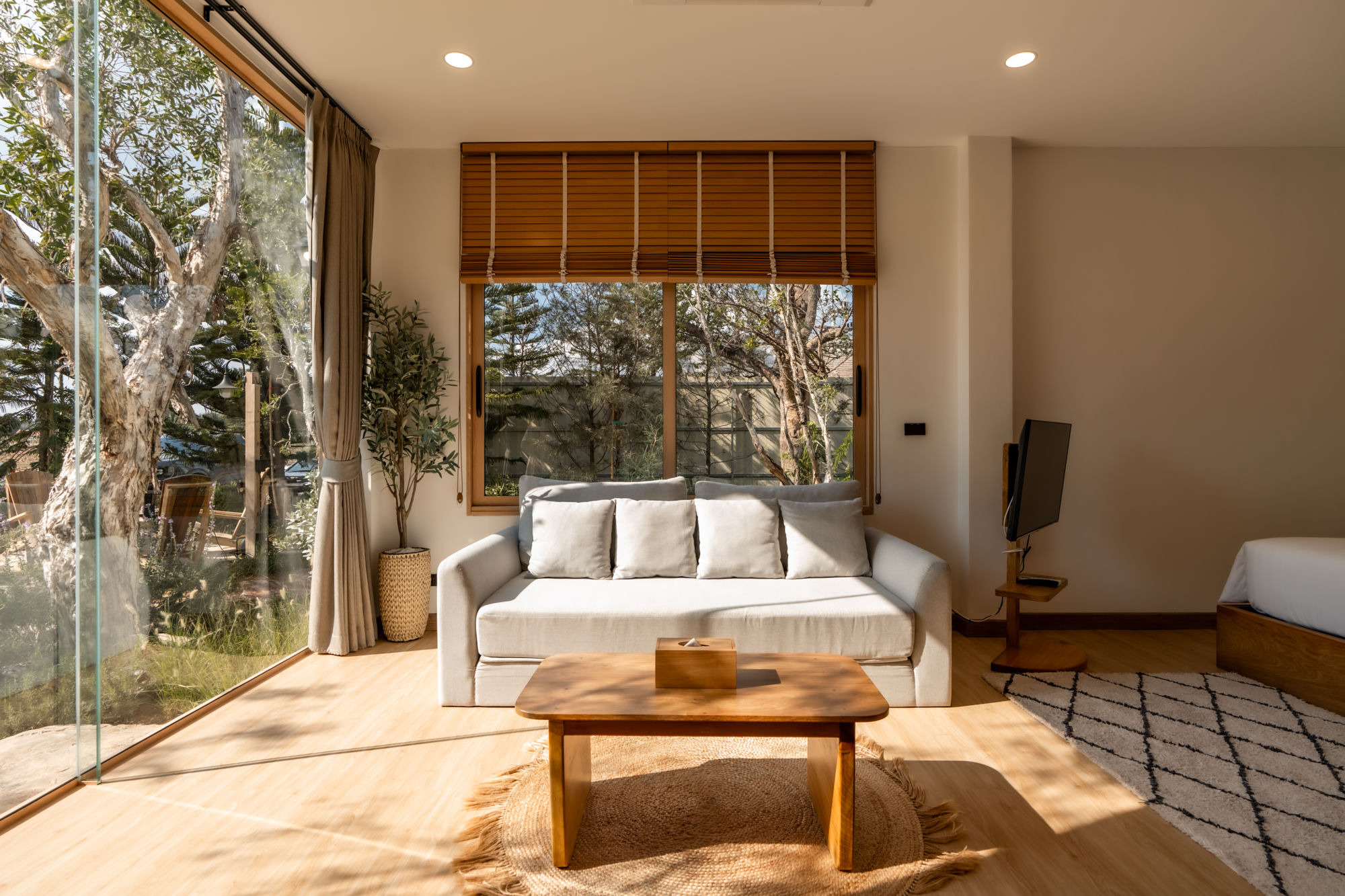 Linen sofa beside window