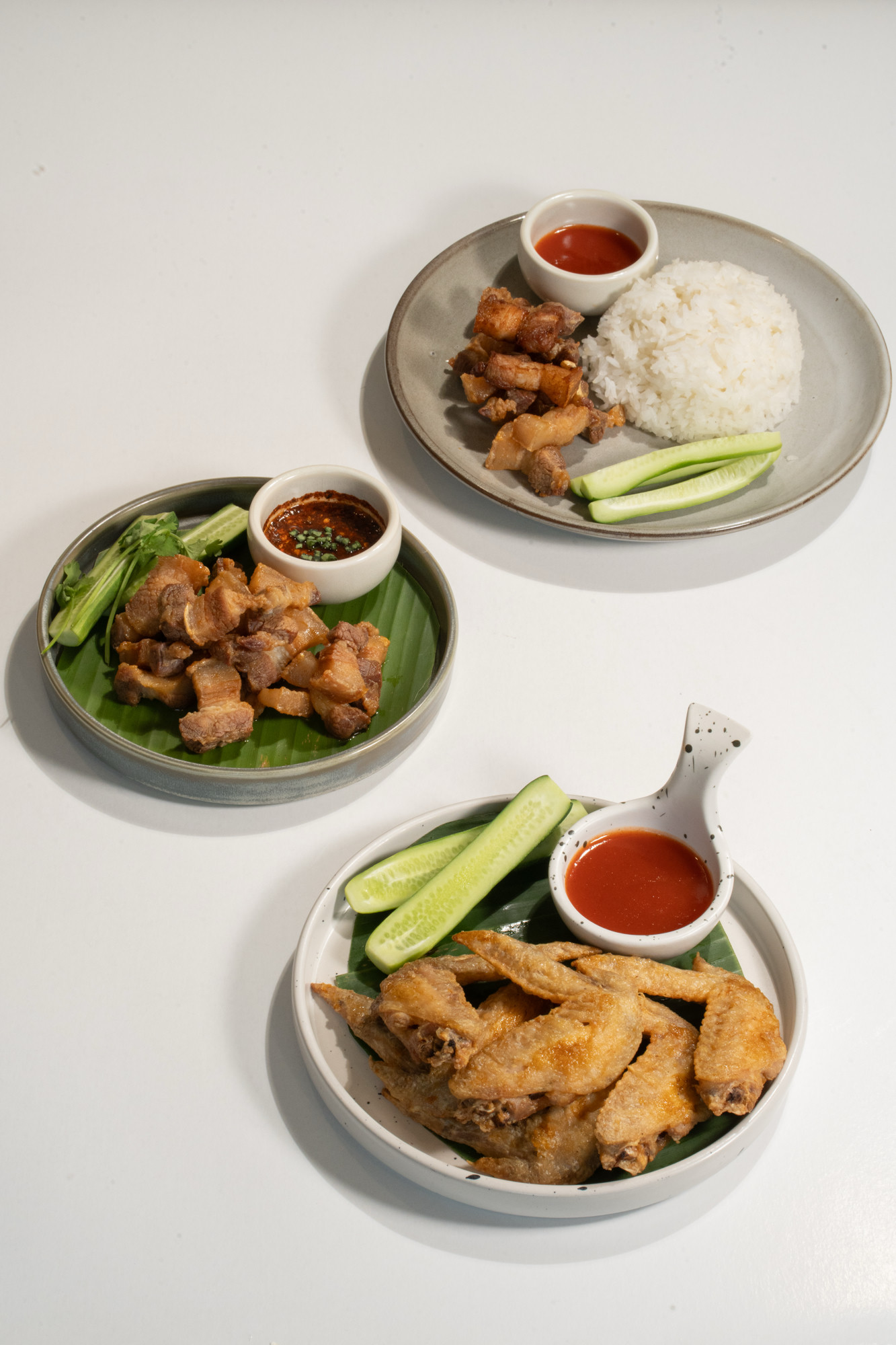 Crispy pork belly, fried chicken wings and rice with crispy pork