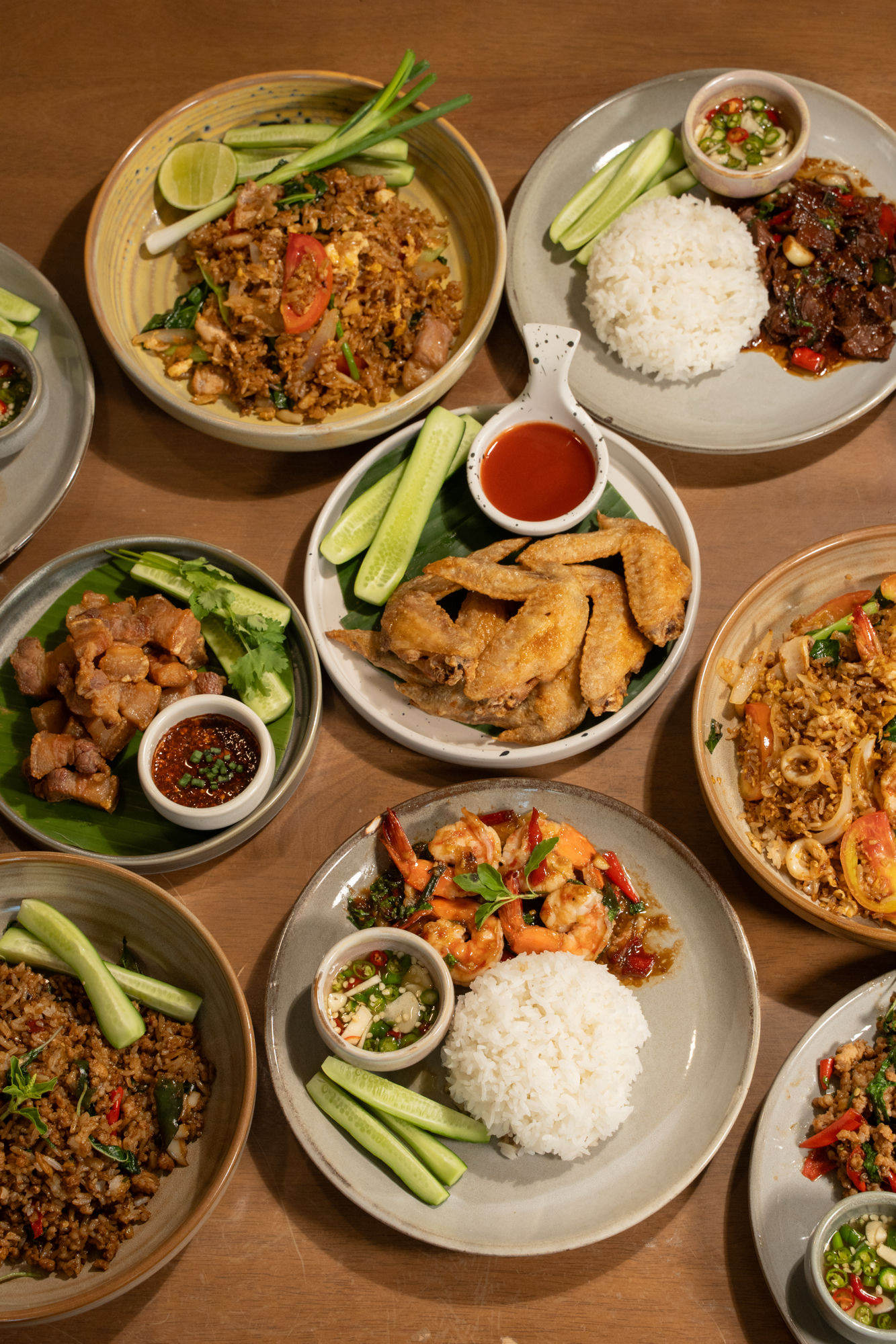 Mixed Thai stir-fry plates with rice and chili dipping sauce